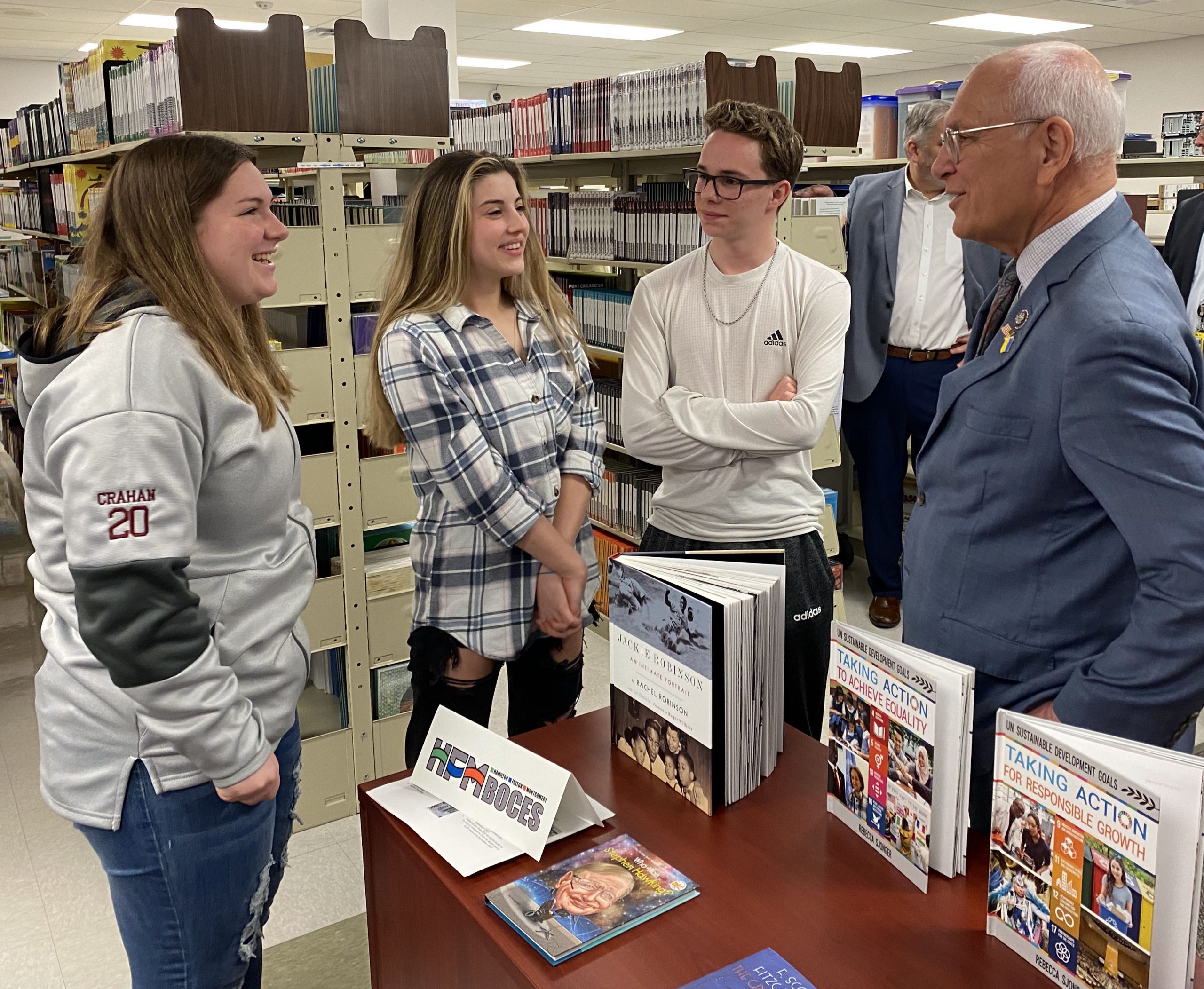 Tonko speaks with three students