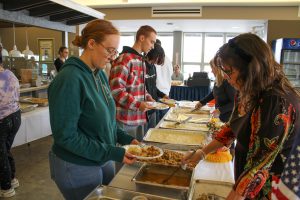 Female administrator serves food to student 