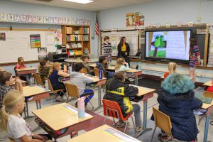 PTECH students give presentation to elementary school students about their story book they authored and illustrated