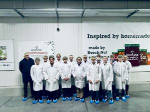 Students enrolled in the Advanced Manufacturing pathway pose for a group photo while on a behind-the-scenes tour of the Beech-Nut manufacturing facility in Amsterdam, NY.