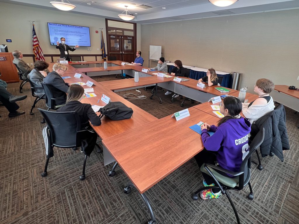 PTECH students sit inside the board room of the Allen House on the FMCC campus and listen intently to their teacher give direction.
