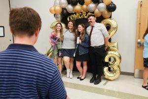 A group of PTECH completers pose for a picture with teacher Rodney Schuyler after the 6th annual HFM PTECH Completion Ceremony.