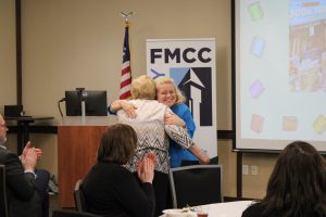 Kristi Beedon hugs Grace Frederes after presenting Frederes with the Ken Smith School Library System Regional Award.