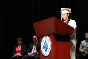Adirondack Academy student Kamri Ahrens stands at the podium while delivering a speech to her fellow classmates during the Adirondack Academy completion ceremony.