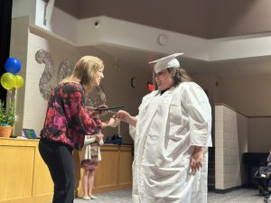 A student is congratulated during a commencement ceremony after earning her Skills Achievement Commencement Credentials.