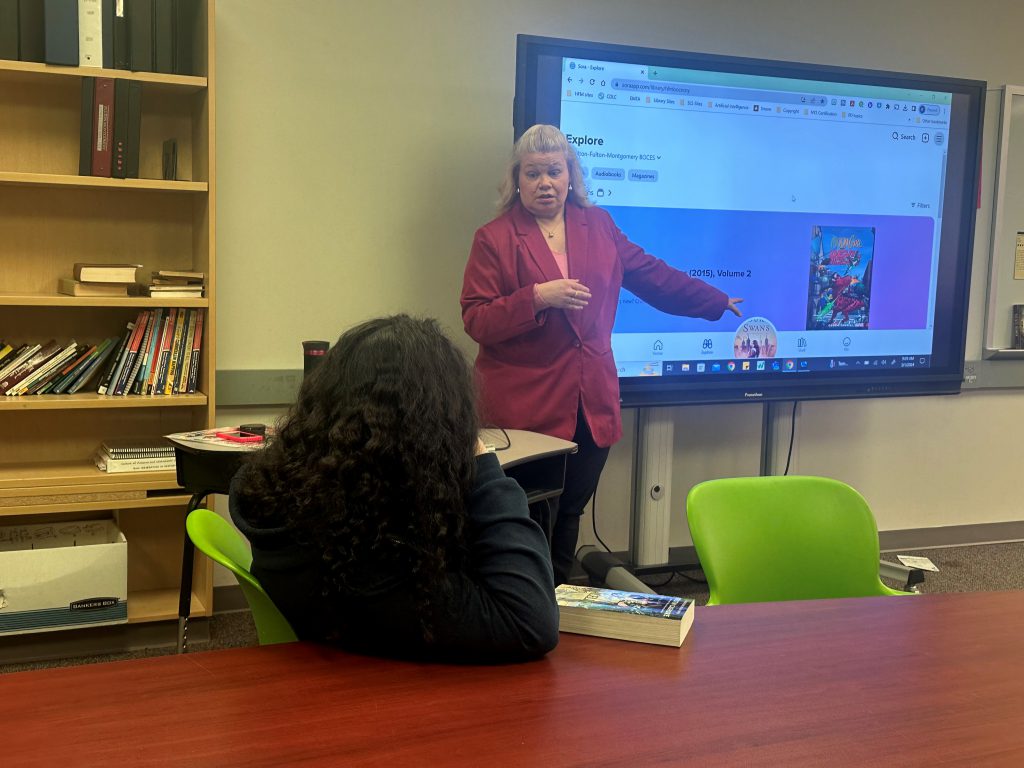 Kristi Beedon, Director of the HFM School Library System, speaks to an Adirondack Academy student about SORA, a free digital/audiobook resource available through the HFM Instructional Resource Center.