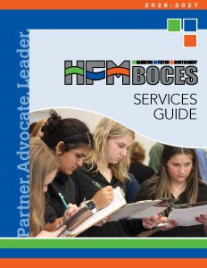 Cover photo of the 2026-27 HFM BOCES Services Guide showing three HFM CTE students holding clipboards and jotting notes during an event they were attending at the HFM BOCES campus.
